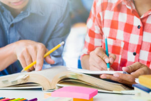 Young students campus helps friend catching up and learning.